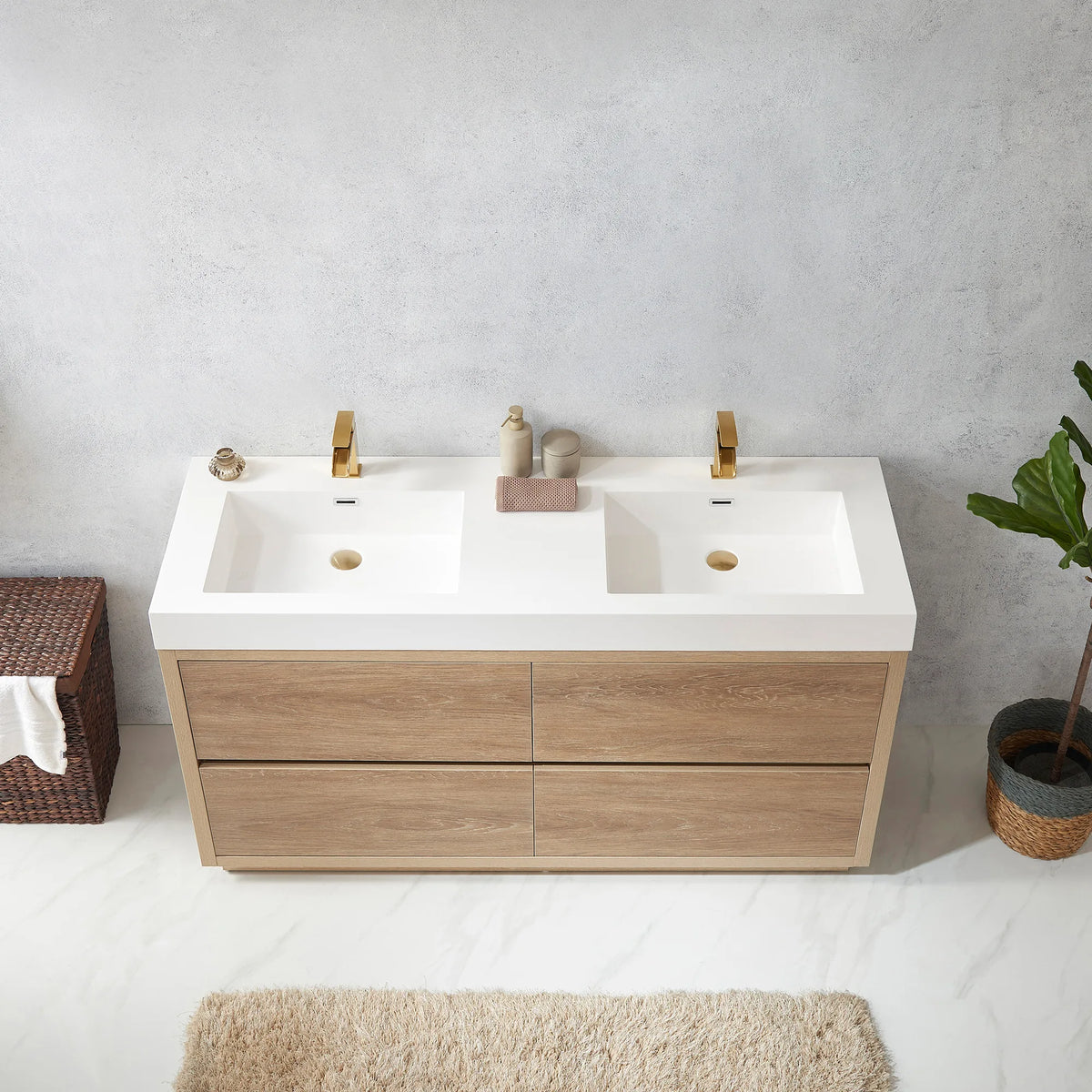 Overhead view of the white integrated double sink top, a soap dispenser in the middle, hamper at left