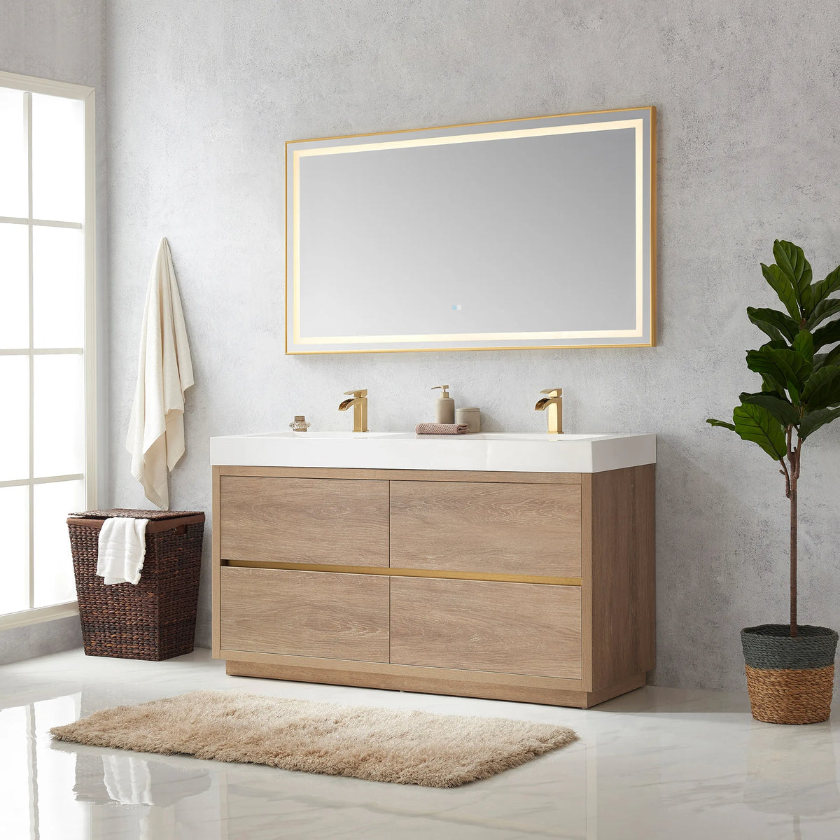 Wide room view of the double vanity with LED mirror, window at left, hamper, plant and rug