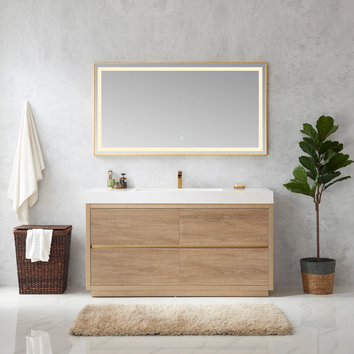 Wide shot of the vanity with mirror, towel on a hook, hamper, rug and plant