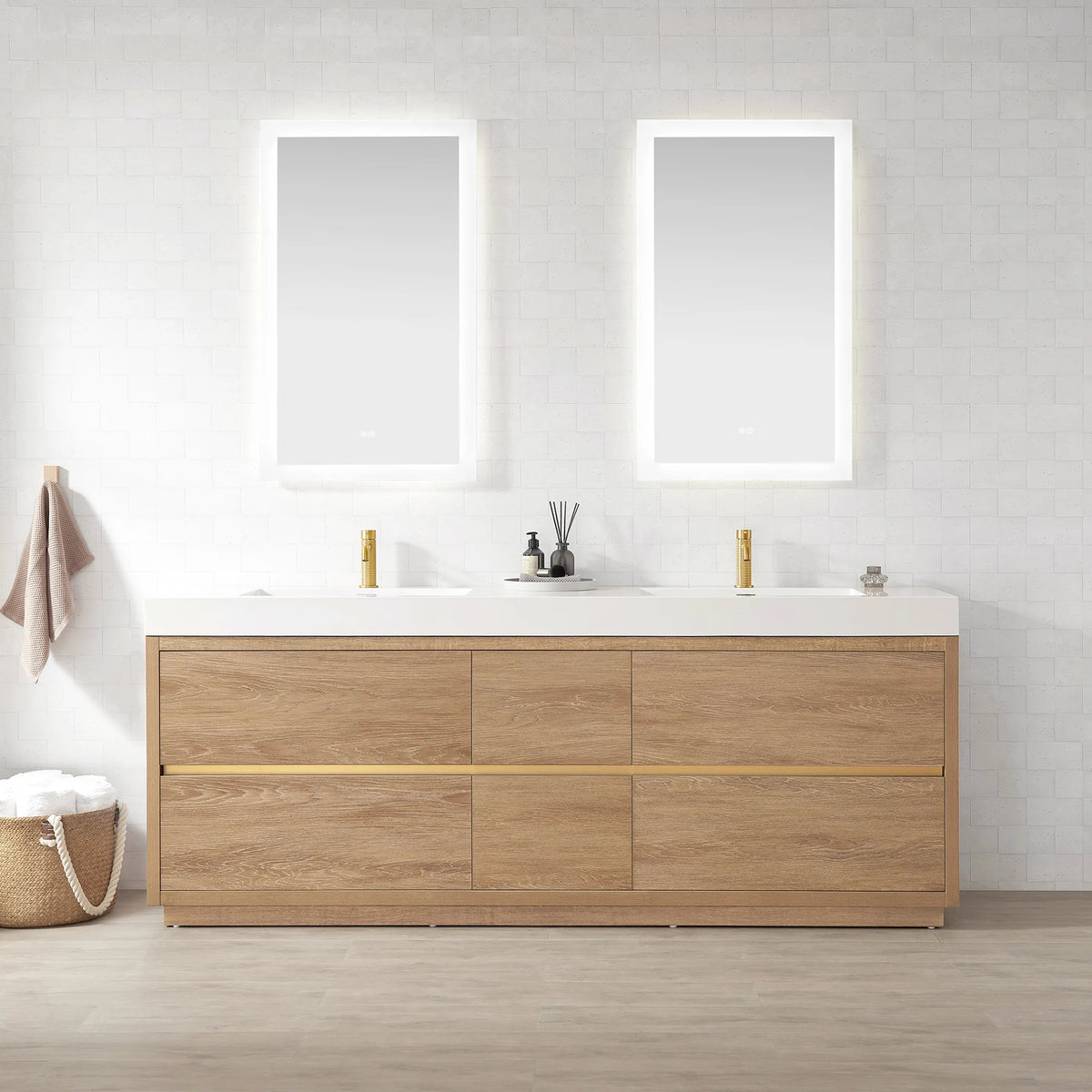 Wide shot of the double vanity with mirrors, hanging towel, basket and diffuser on top