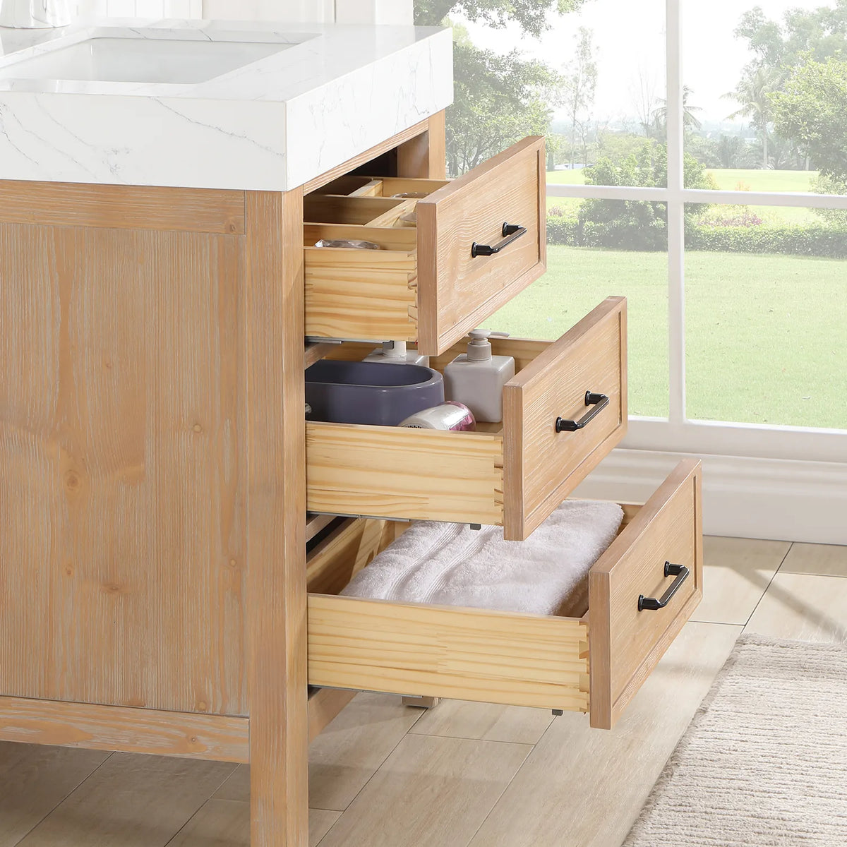 Open drawers filled with bath items on the 24-inch single vanity