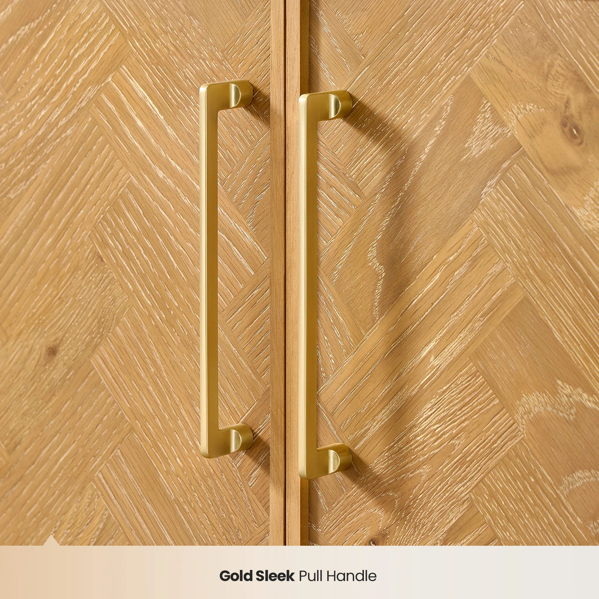 Close detail of gold pull handles against light oak herringbone panels