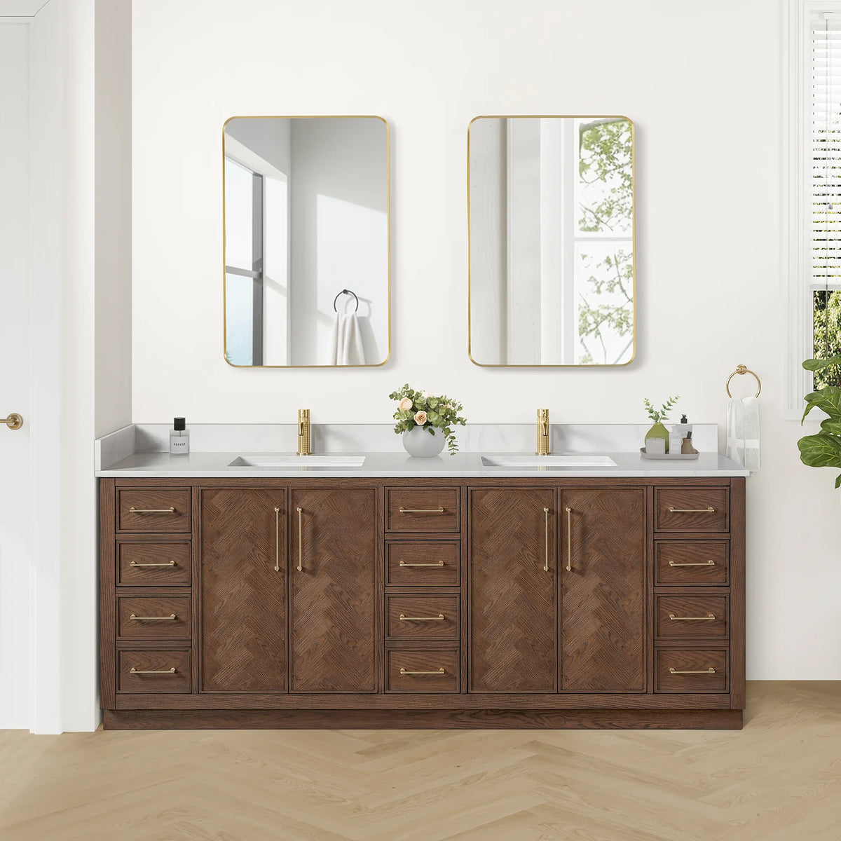 Bathroom scene with the 84-inch double vanity, its matching pair of mirrors and a towel ring, plus flowers on the quartz top