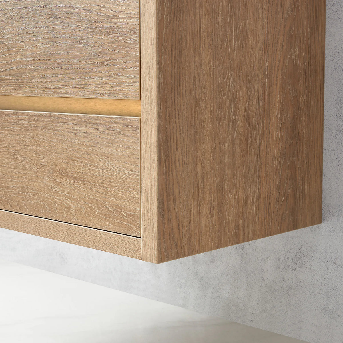 Side panel and front of the floating cabinet raised off the floor, with brushed gold hardware