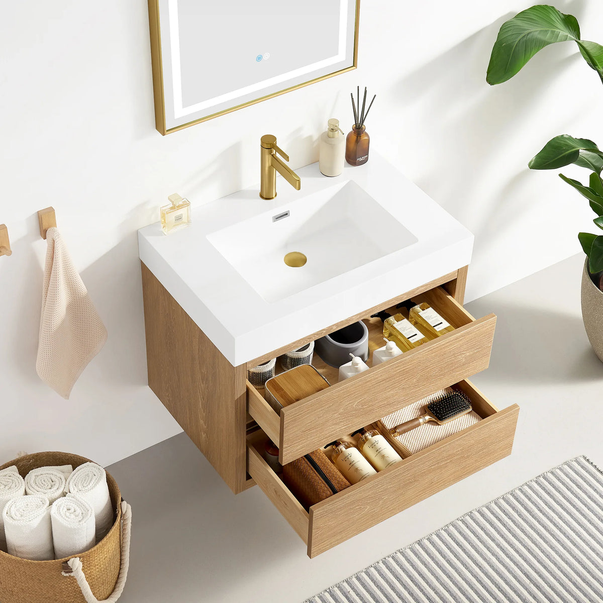 Open drawers on the North American Oak floating vanity with inserts for small items, sink top above