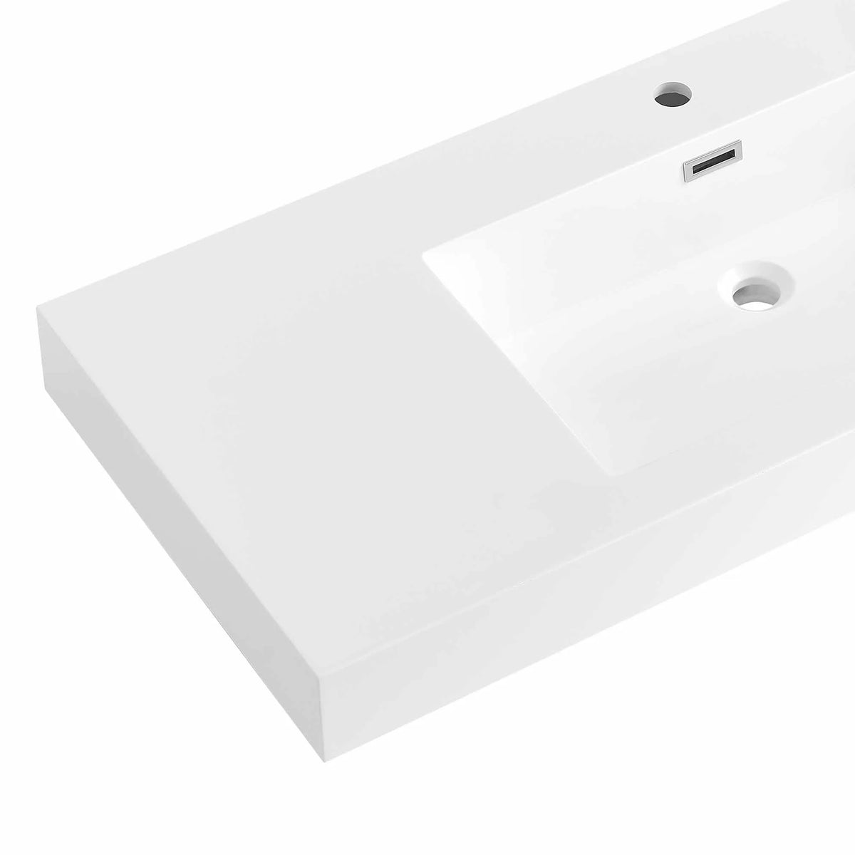 Detail of the white sink top by itself, showing the basin, drain and faucet hole