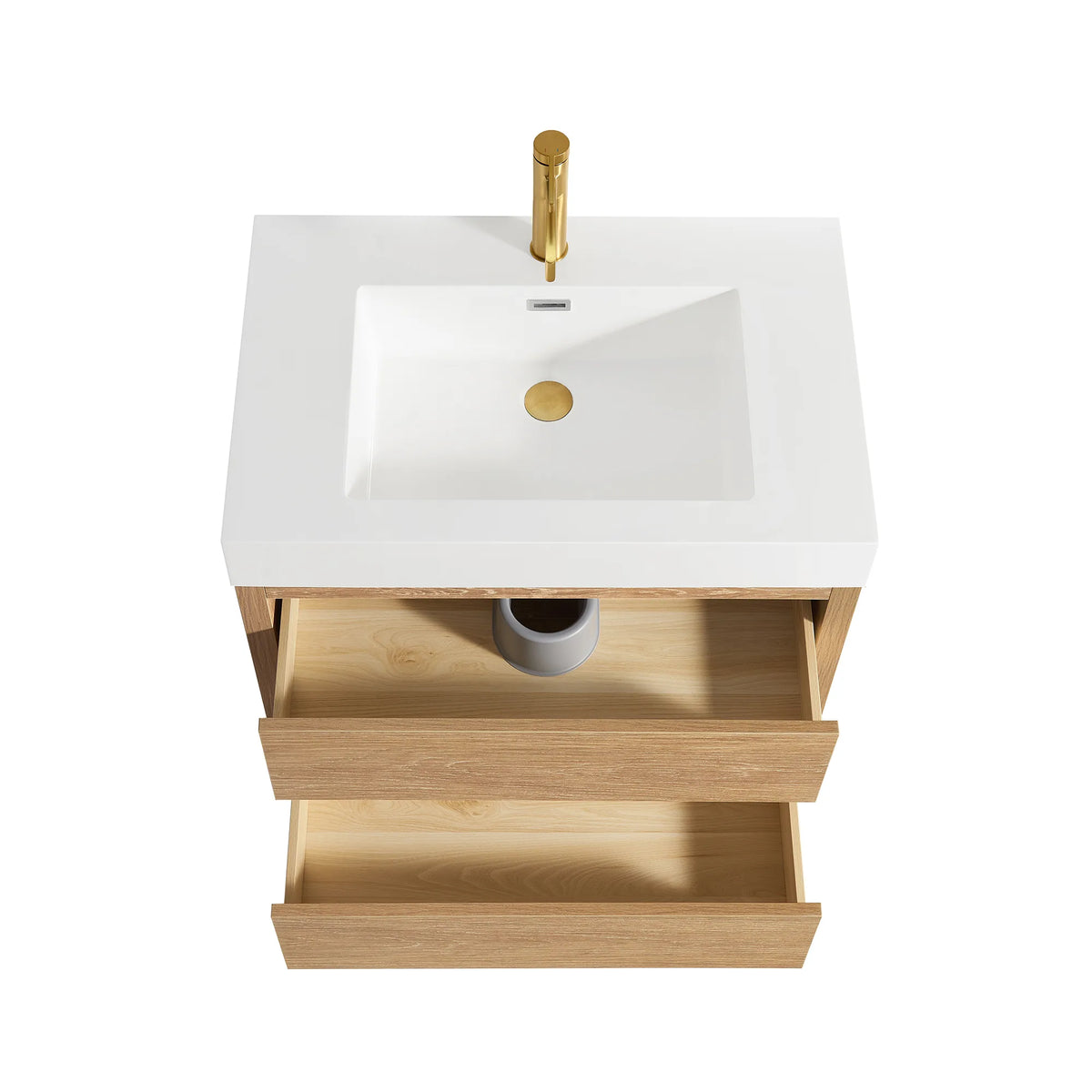 Studio view from above of the sink top and an open drawer, gold faucet displayed