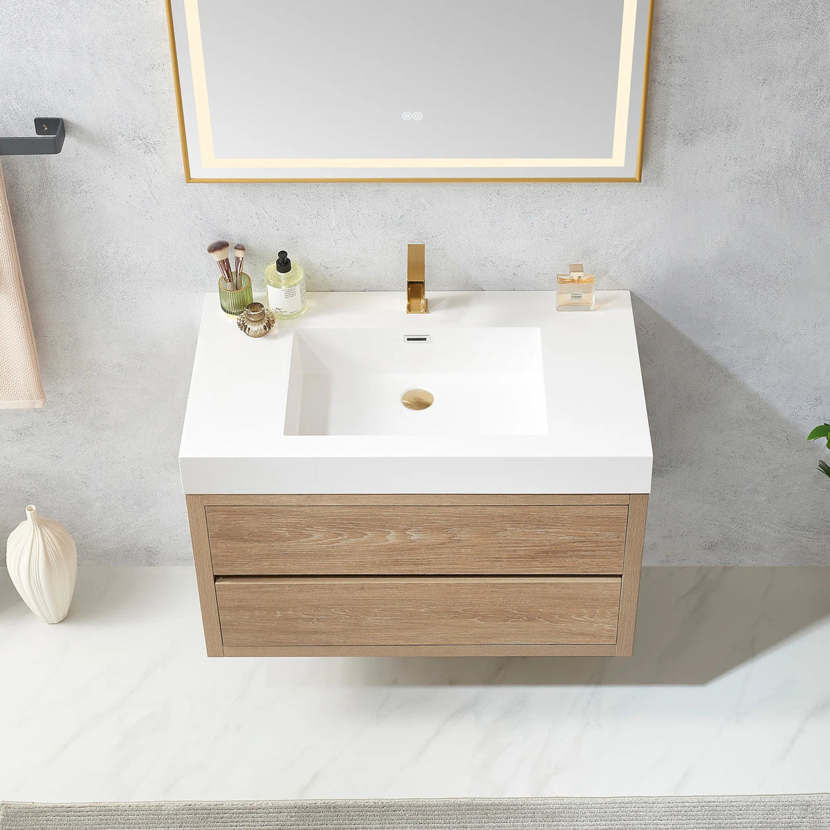 Detail of the 36 inch integrated sink top and cabinet front, a reed diffuser at its edge