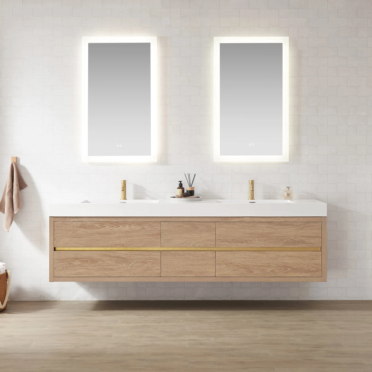 Long wall-mount double sink vanity with a diffuser and small tray on the top, pale floor below