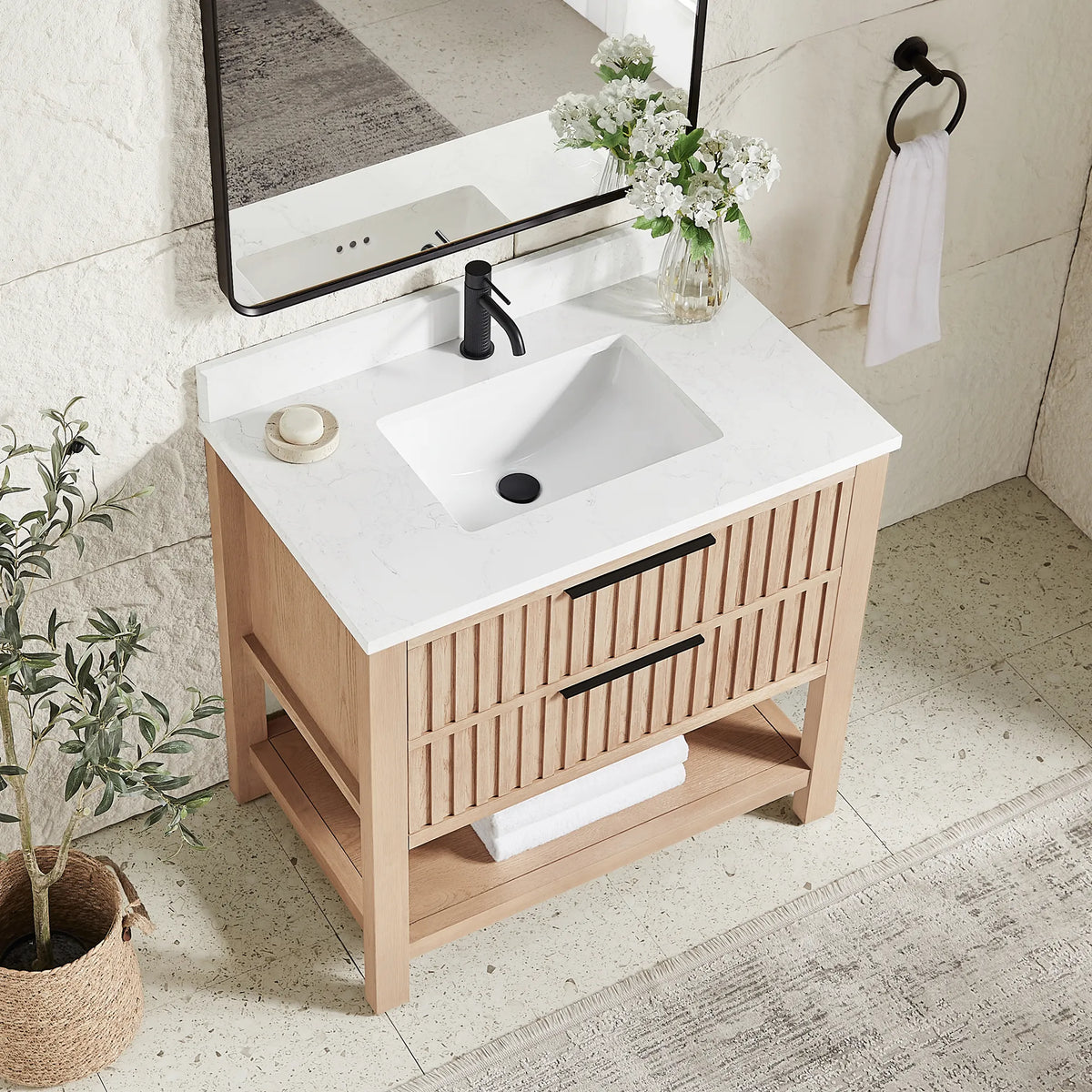 Top-down angle: a stone-composite top and ceramic undermount basin on the 36-inch Aged Natural Oak cabinet