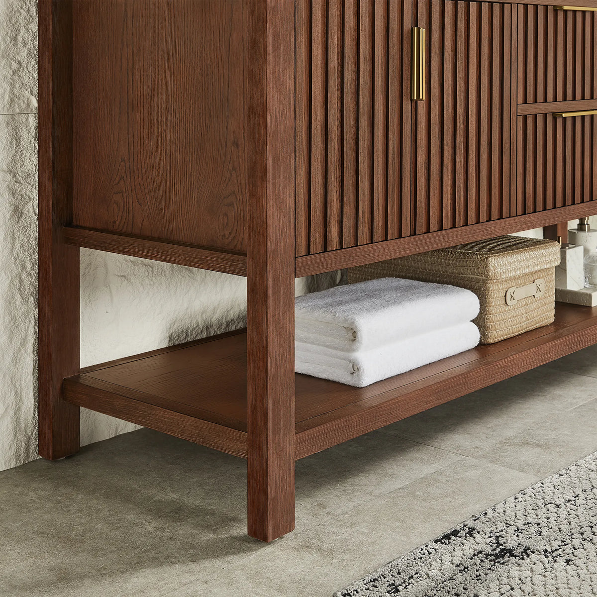 Towels stacked beside a basket on the base shelf, 48-inch Aged Dark Brown Oak cabinet