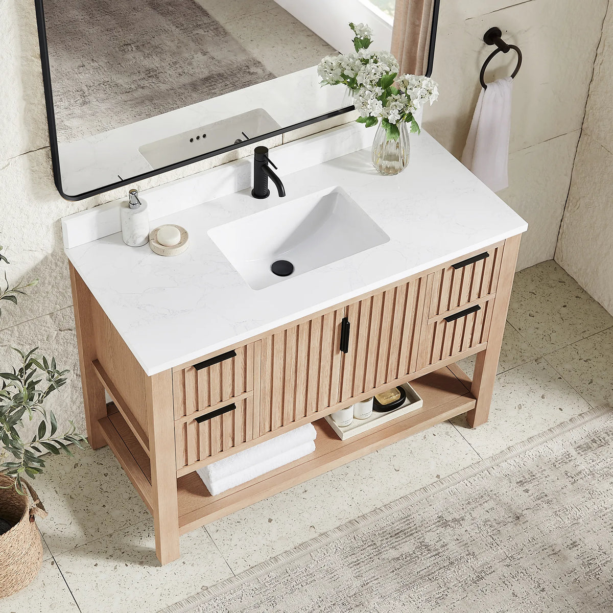 Top-down angle: a stone-composite top and ceramic undermount basin on the 48-inch Aged Natural Oak cabinet