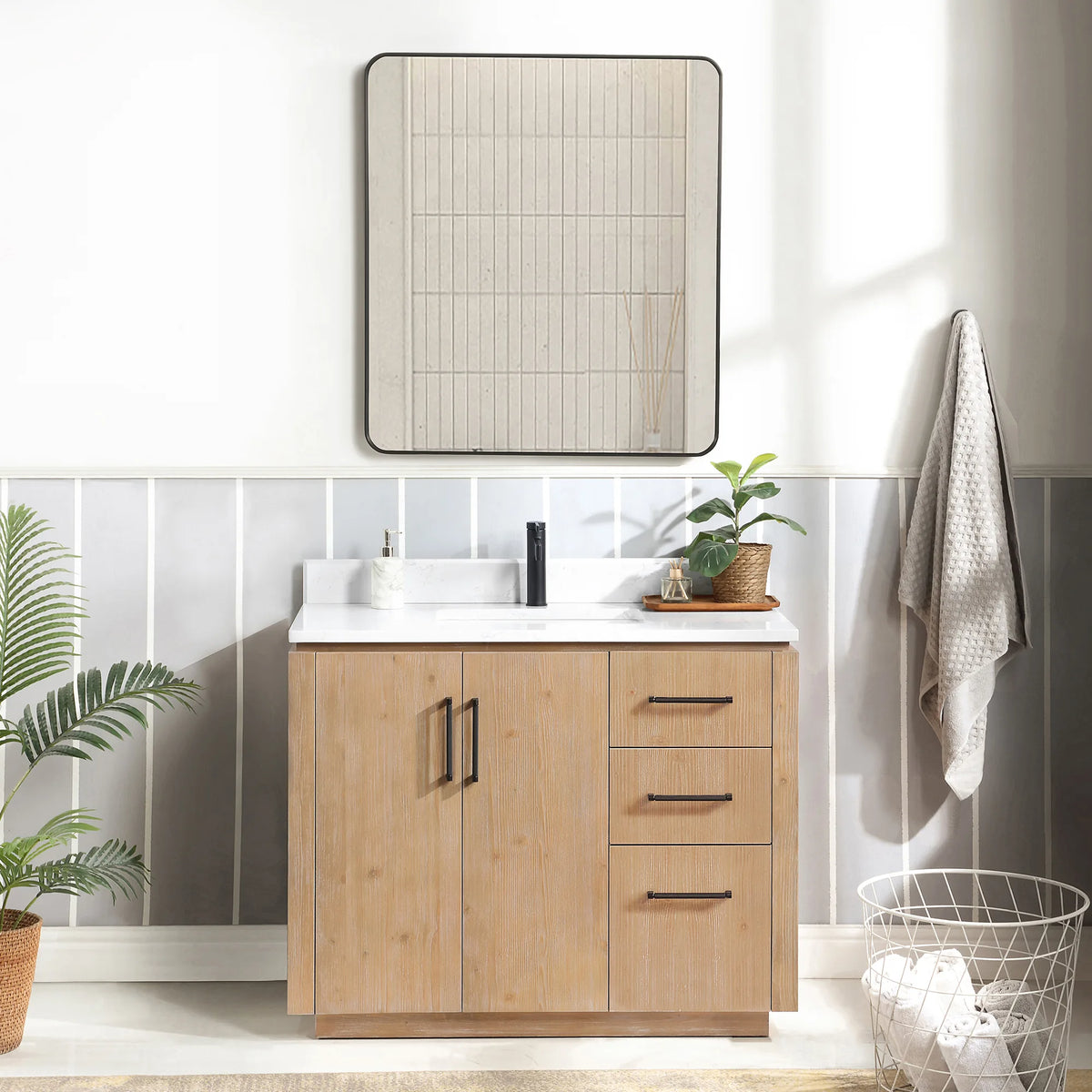 Bathroom scene with a 42 inch Fir Wood Brown vanity, a framed mirror and a wire laundry basket on the floor