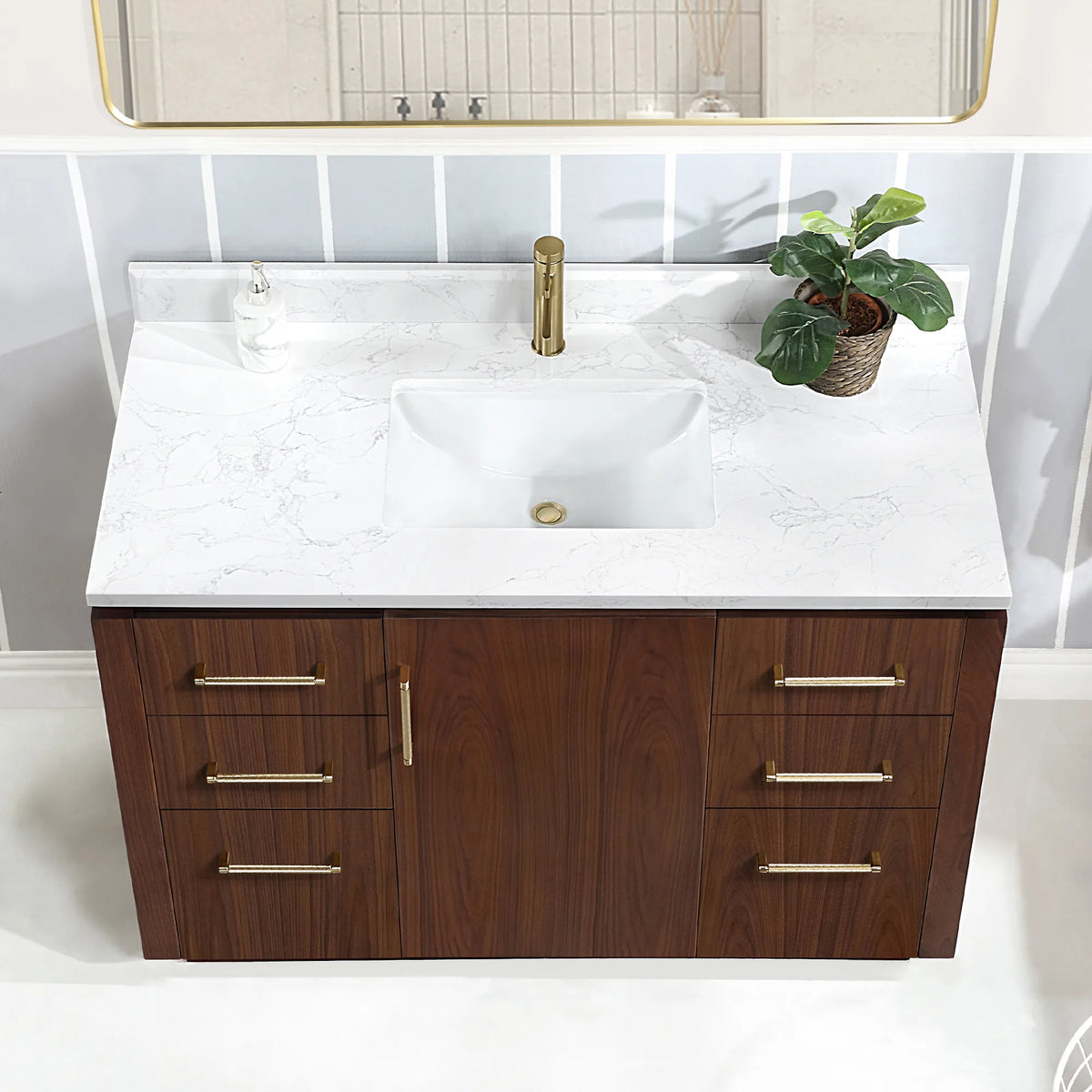 High-angle close view of the undermount ceramic sink on the white grain composite stone top, drawers below