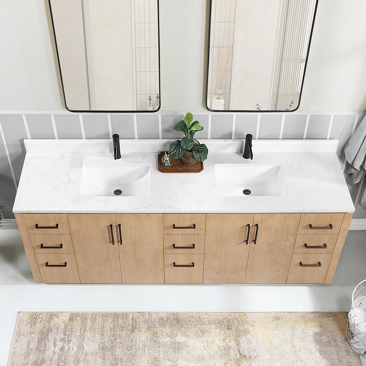 Close-up of the long stone top and undermount sink area above the drawers and doors