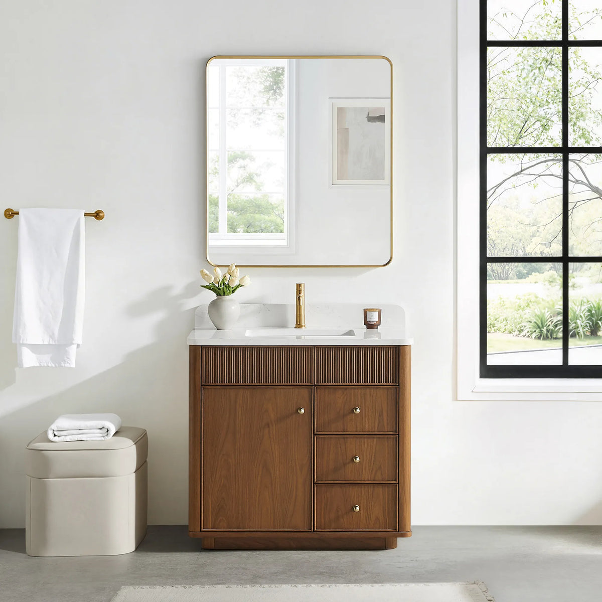 Matching rounded-rectangle gold mirror above the Natural Walnut vanity in a bathroom with a black-framed window