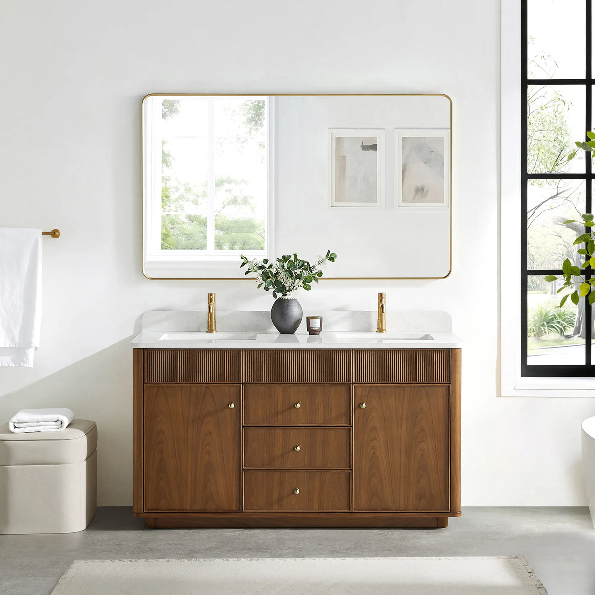 Matching wide rounded-rectangle gold mirror above the Natural Walnut vanity in a bathroom with a black-framed window