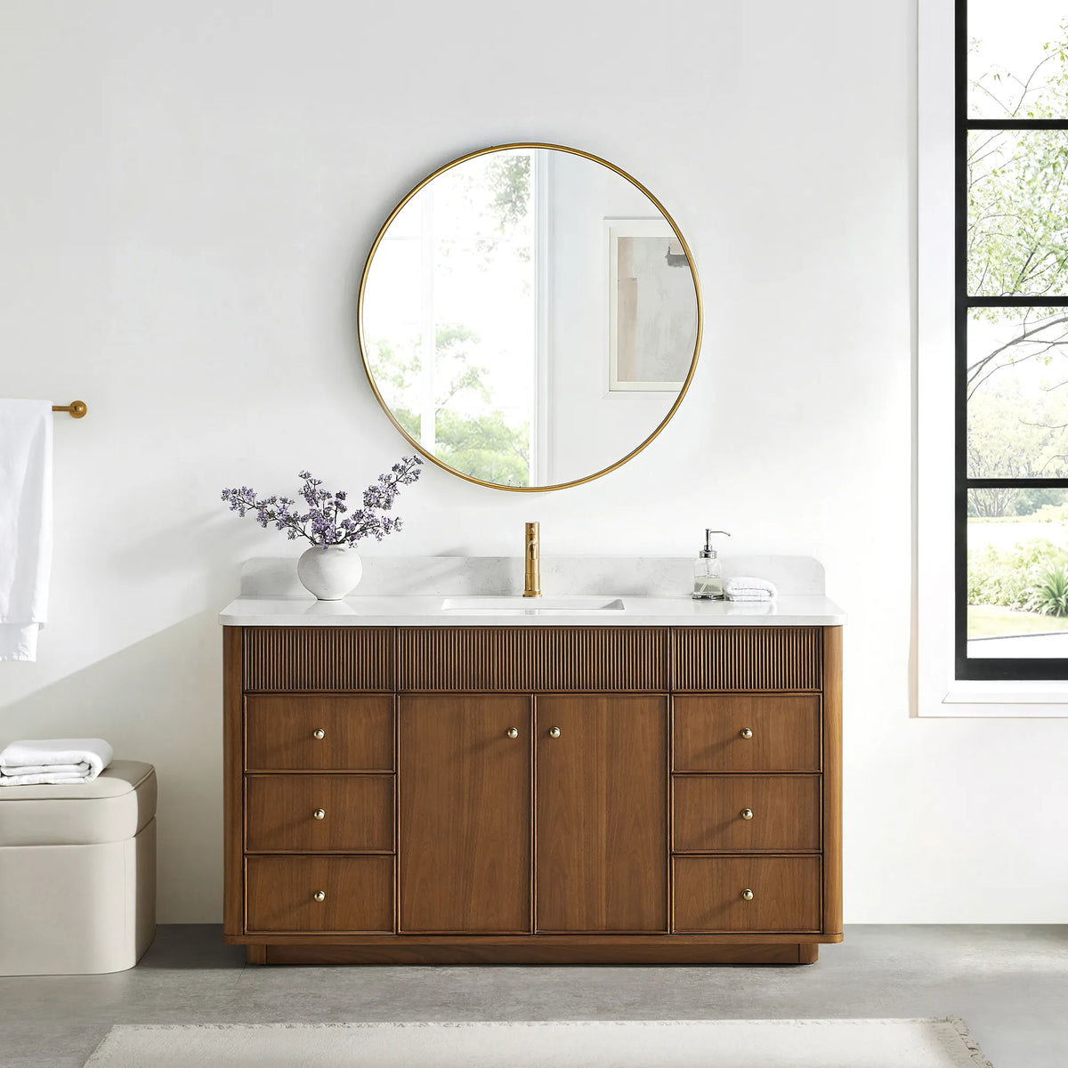 Matching round gold mirror above the Natural Walnut vanity in a bathroom with a black-framed window