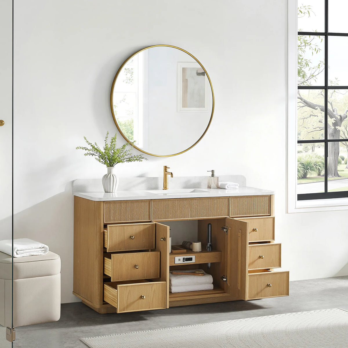 Open storage on the Washed Ash Grey vanity: doors and drawers swung back and towels stacked on the shelf