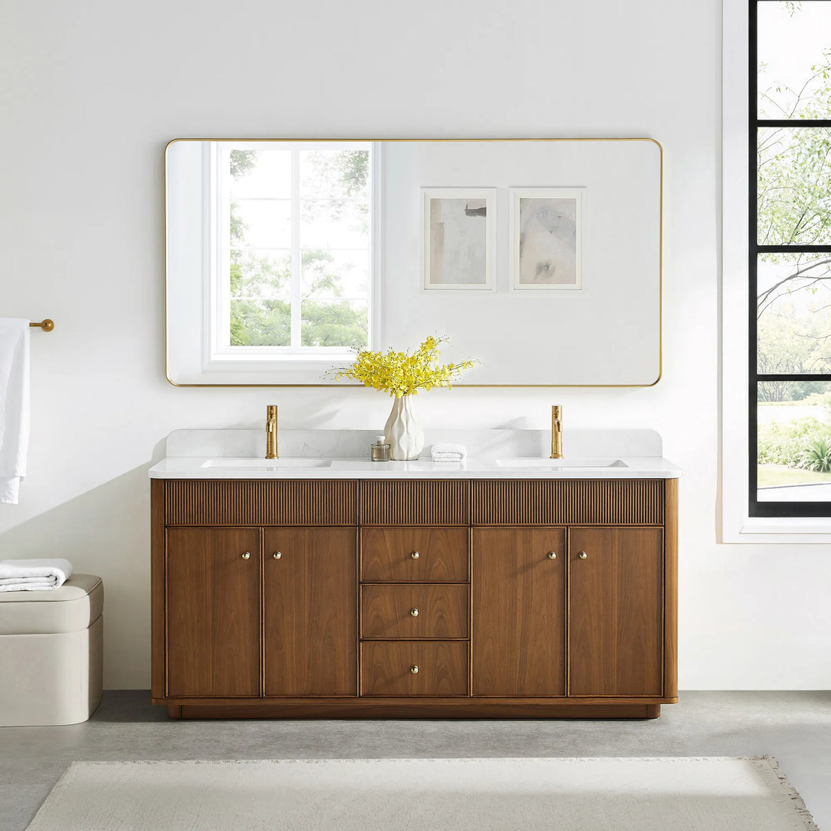 Matching wide rounded-rectangle gold mirror above the Natural Walnut vanity in a bathroom with a black-framed window