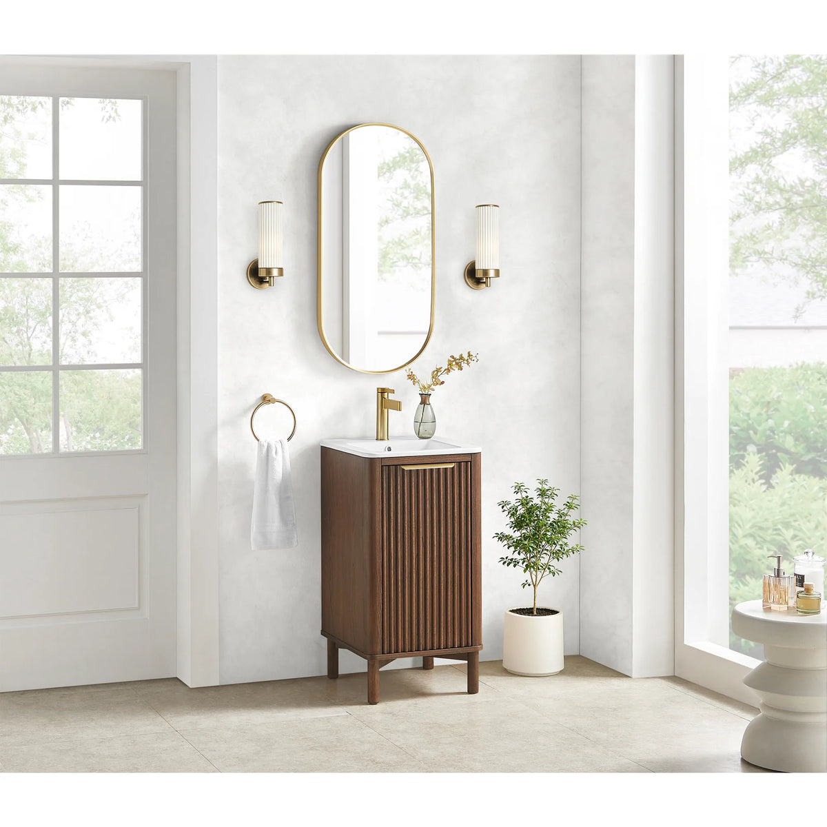 Bright bathroom view of the 18-inch single vanity, a door to the left and a white side table at the right edge