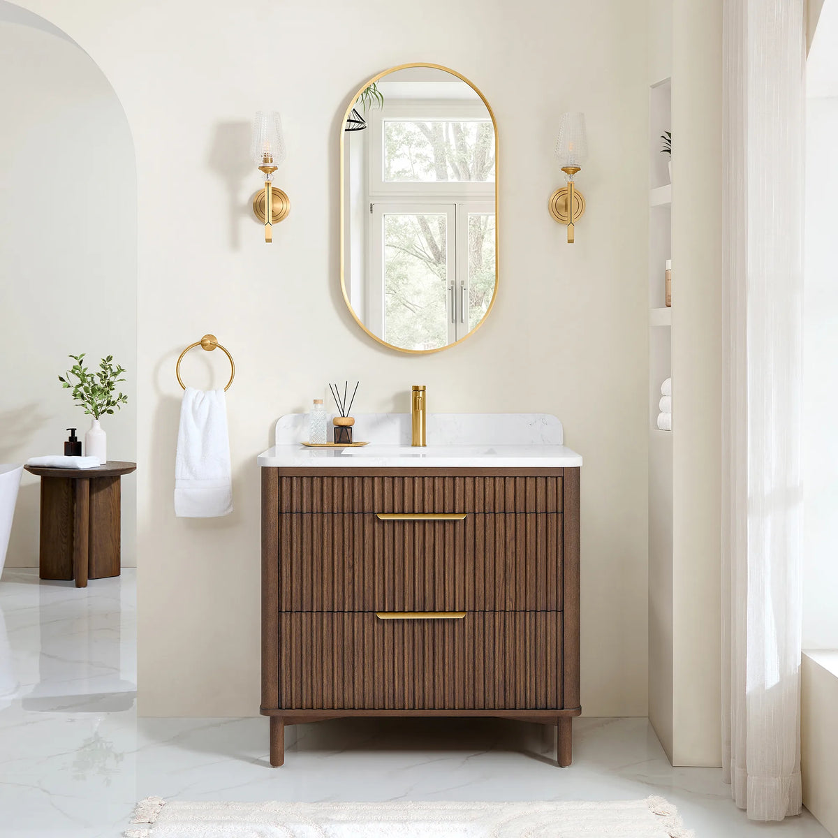 Bathroom scene for the 36-inch vanity under its matching mirror, with wall sconces, a towel ring and a small side table
