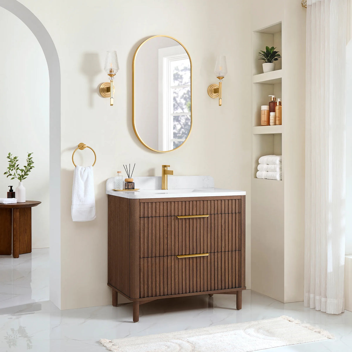 Wide room view of the 36-inch single vanity beside a small plant and a side table, light from a tall window