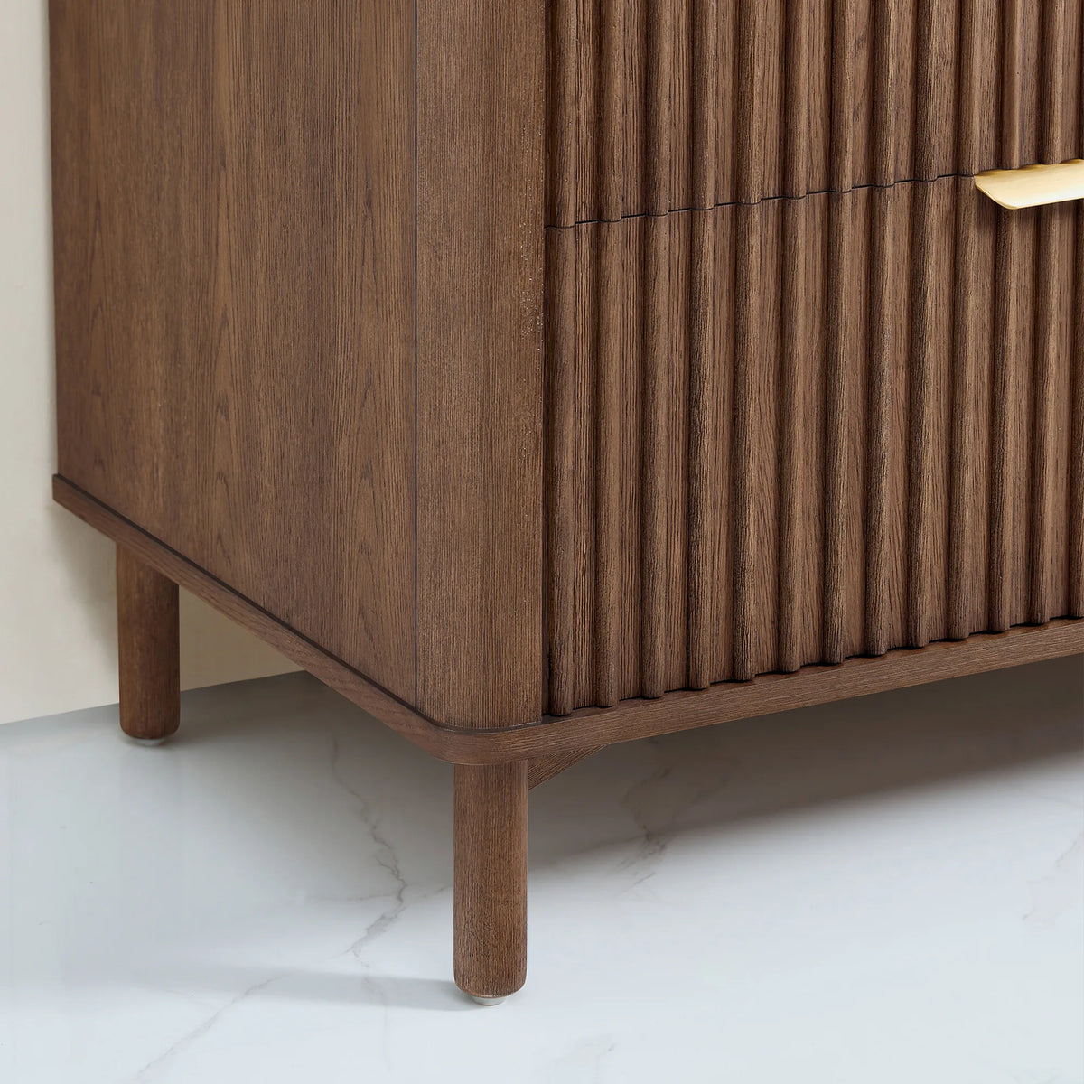Base detail of the 36-inch Aged Dark Brown Oak vanity: a cylindrical leg and a curved apron, plus a ribbed side panel