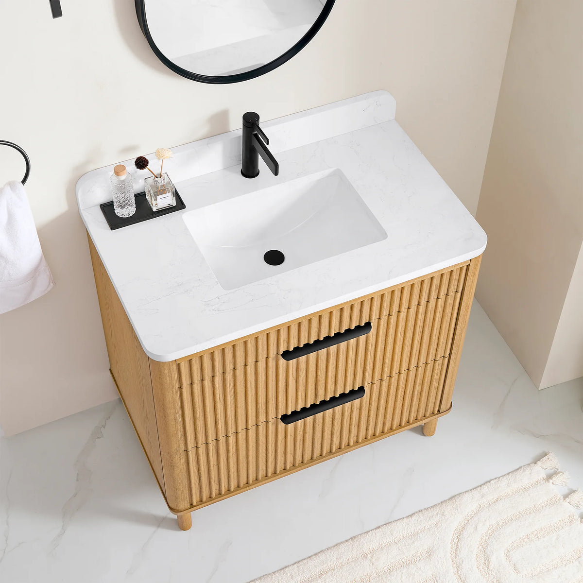 High-angle look at the 36-inch light oak vanity and its two drawers, with a cream rug on a pale floor