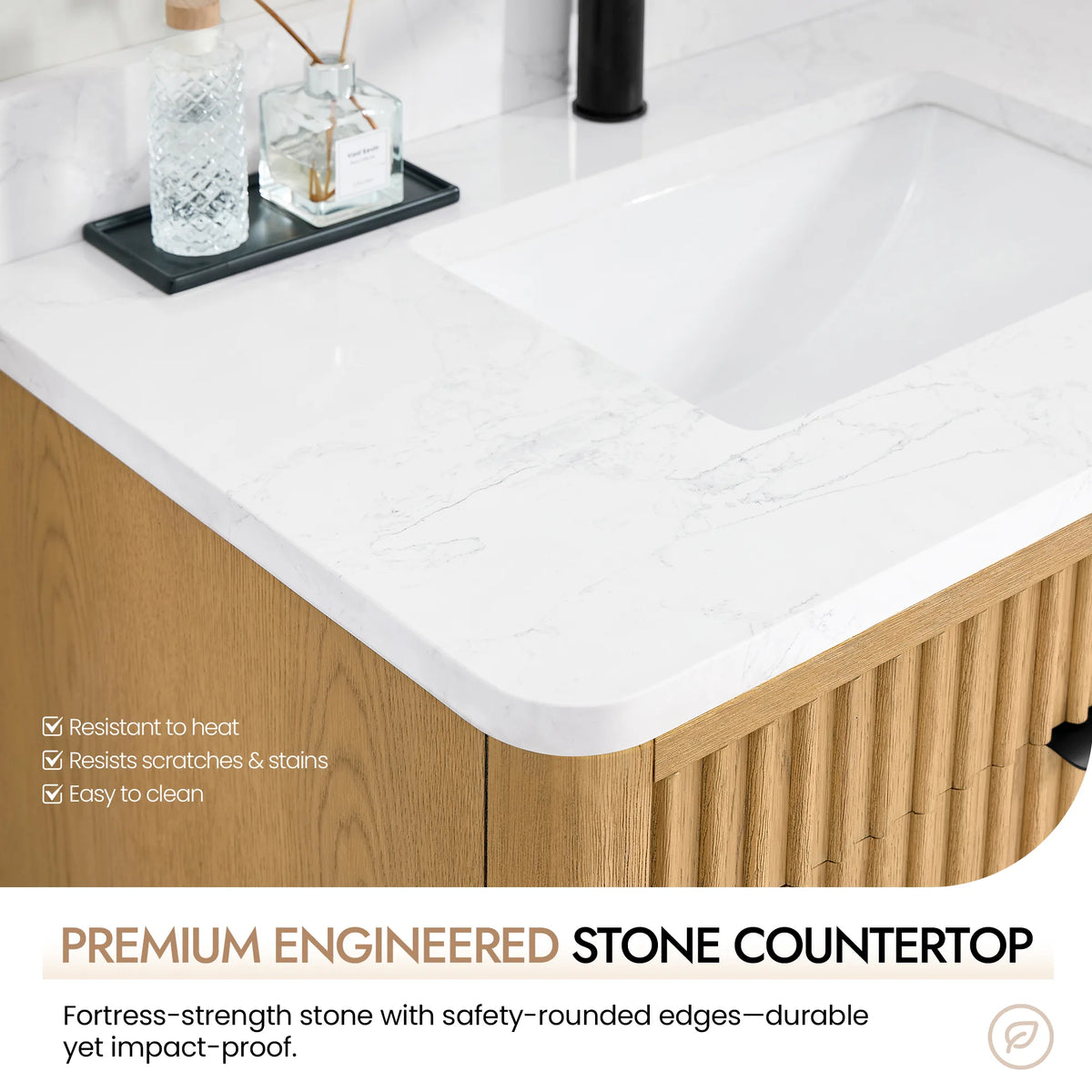 Close view of the countertop's safety-rounded corner and the basin, with a dark tray of perfume bottles
