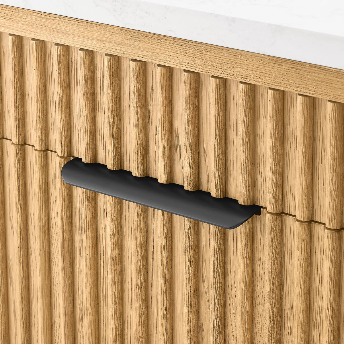 Curved black handle against vertical ribs of pale oak, from the 36-inch single vanity