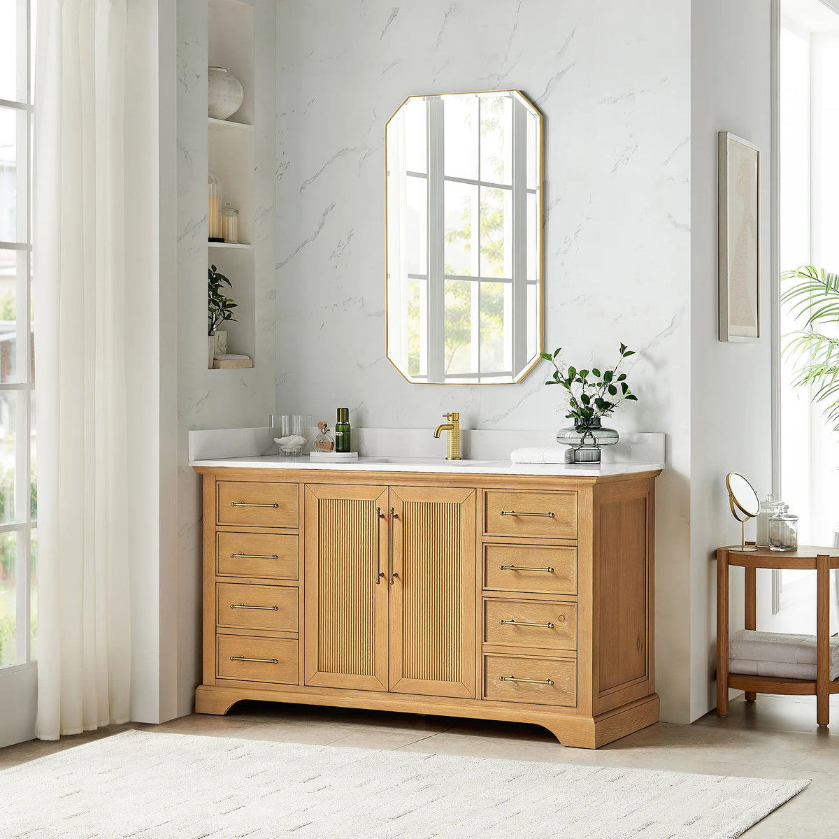 Room scene: Oak Natural Brown single vanity with an octagonal mirror above and a round wooden side table alongside