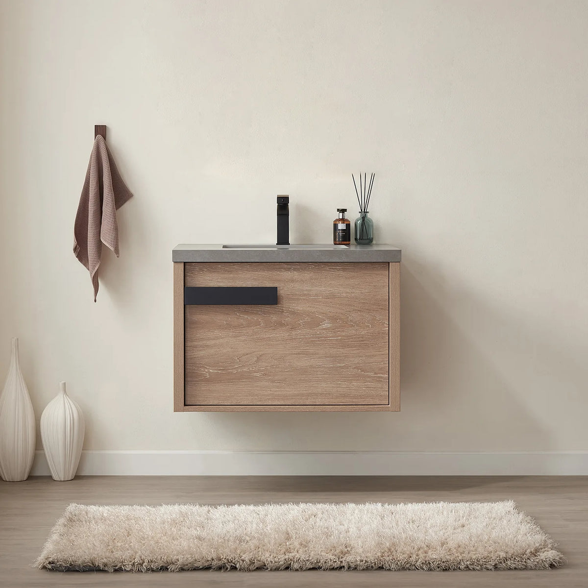 Floating oak-grain cabinet with a black bar pull, shown in a cream-walled room