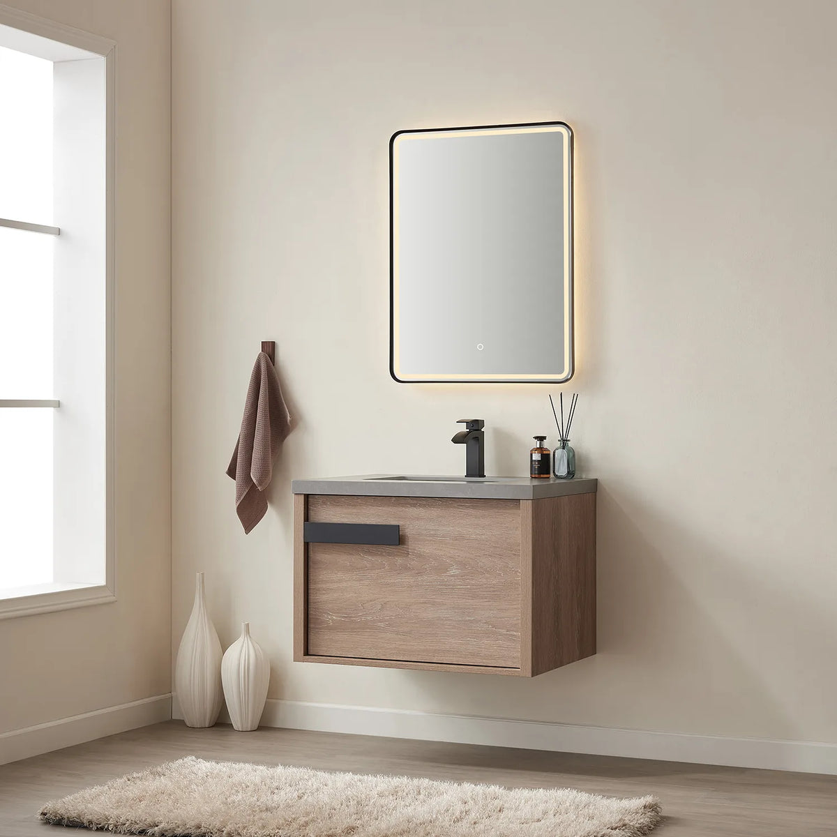 Wide bathroom view with the lit mirror above the floating cabinet