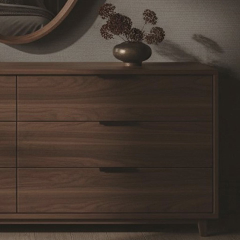 A short video of a wooden dresser with round mirror in a dimly lit room