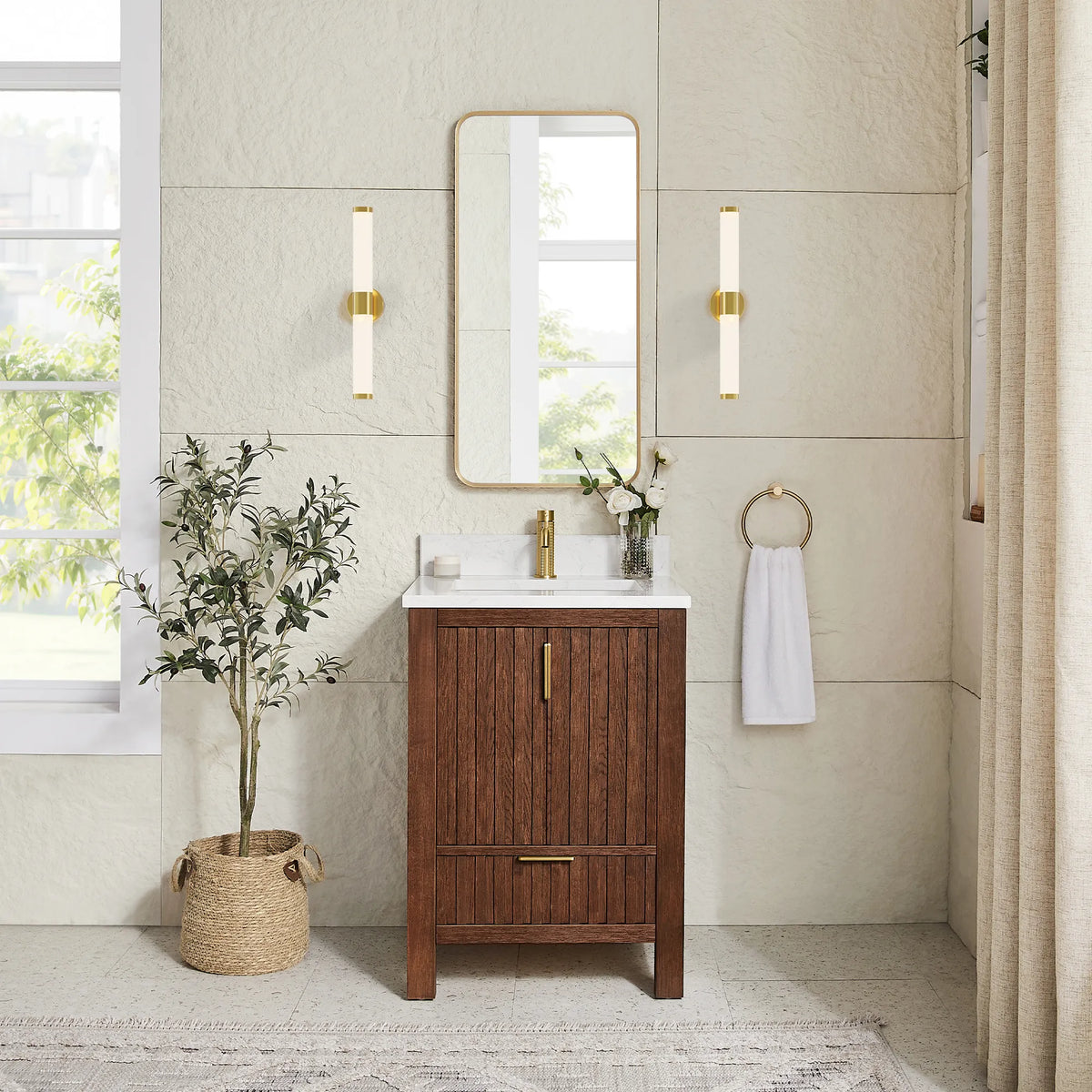 Matching gold mirror hung over the 24-inch Aged Dark Brown Oak cabinet, with wall sconces and a potted plant