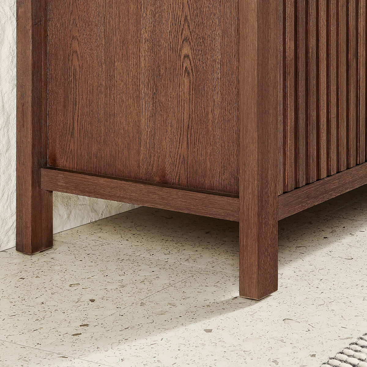 Square corner leg meeting a grooved side panel on the 24-inch Aged Dark Brown Oak vanity