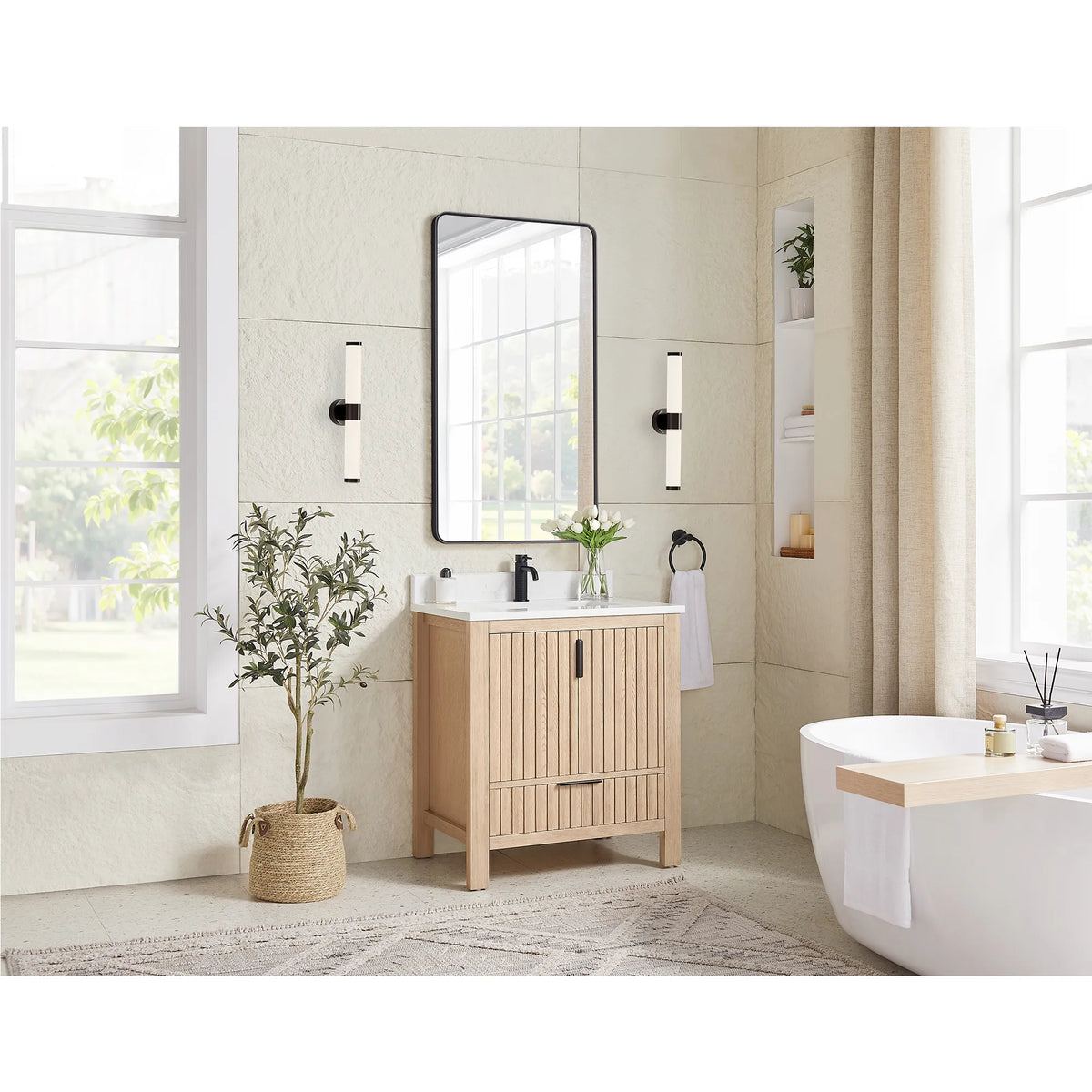 Wide room shot with a tub and window light behind the 30-inch Aged Natural Oak vanity