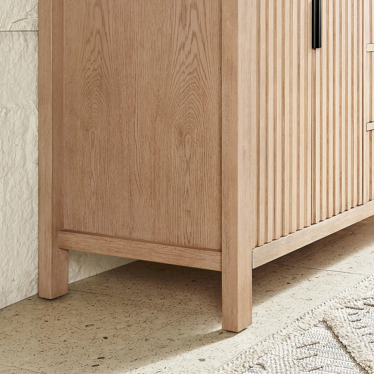 Square corner leg meeting a grooved side panel on the 48-inch Aged Natural Oak vanity