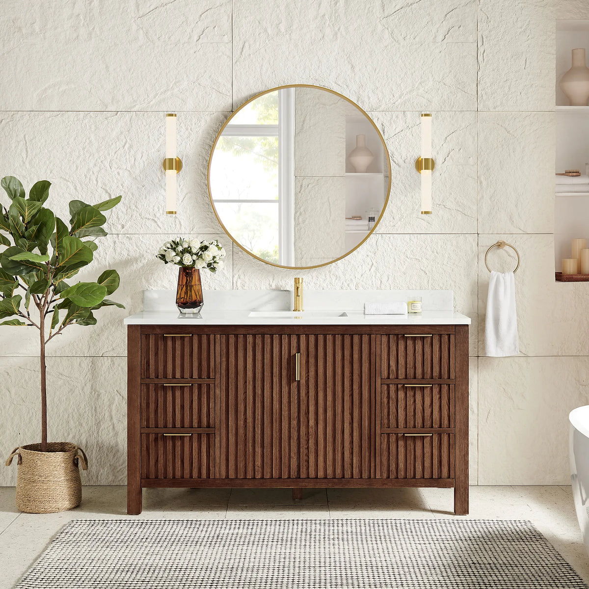 Matching circular gold mirror hung over the 60-inch Aged Dark Brown Oak cabinet, with wall sconces and a tall plant