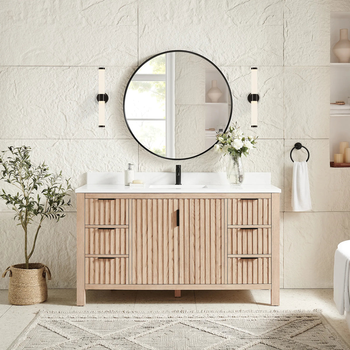 Matching circular black mirror hung over the 60-inch Aged Natural Oak cabinet, with wall sconces and a plant