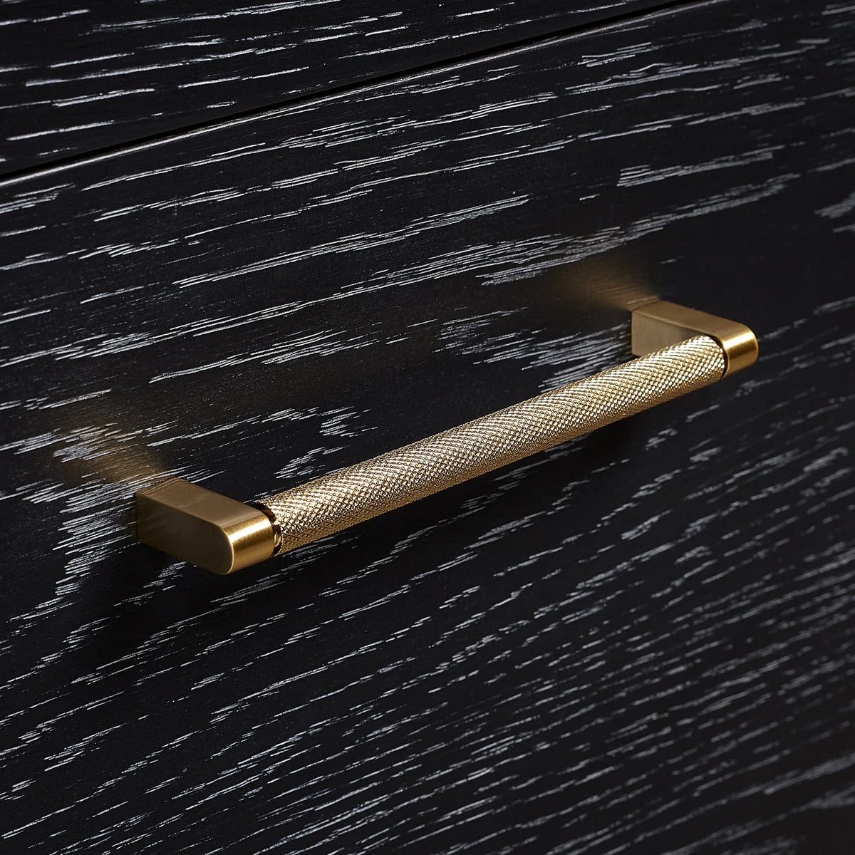 Macro: brushed gold hardware on a Fir Wood Black cabinet door or drawer