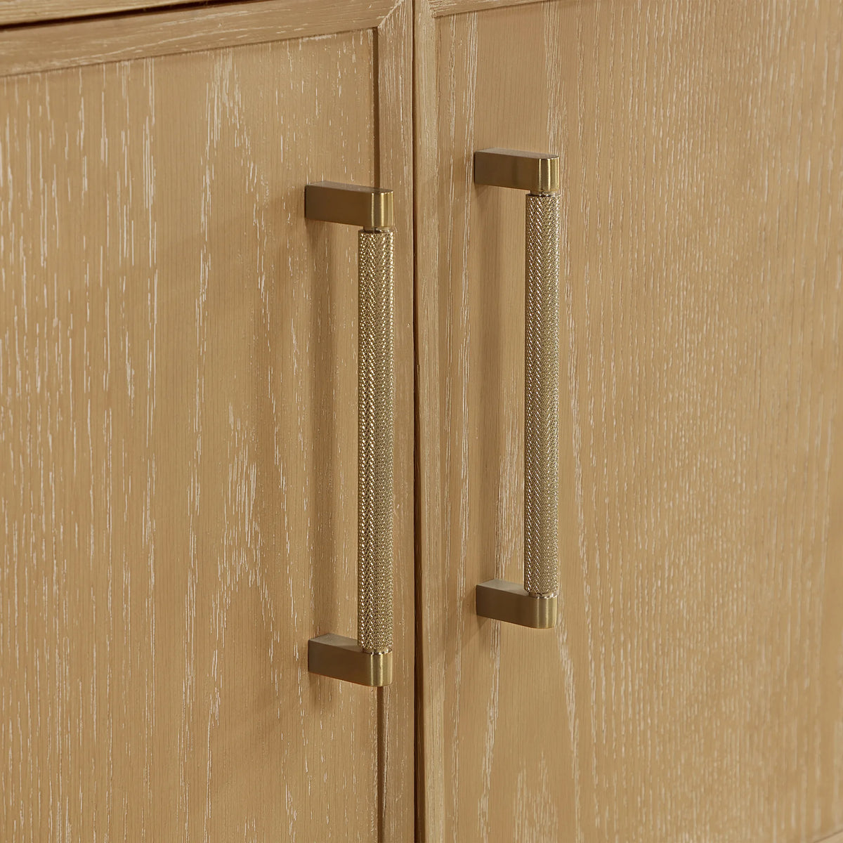 Door hardware up close: slim vertical handles with a knurled brushed gold finish, 36-inch model