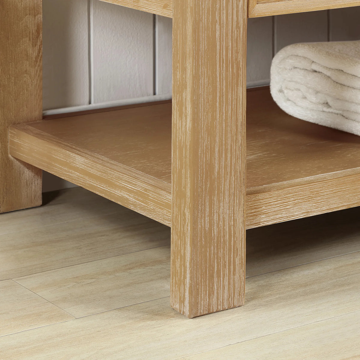 Close view of the open shelf and square leg on the freestanding base, 36-inch model