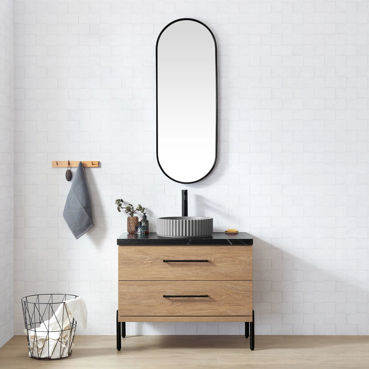 White brick-tile bathroom with the oval mirror and the oak vanity