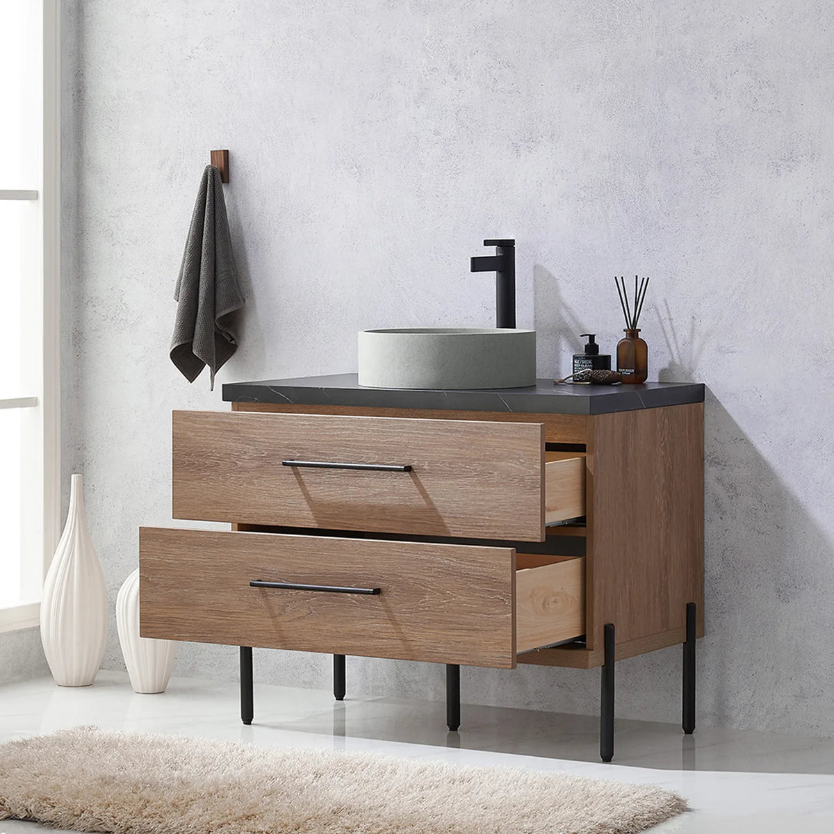 Pulled-out drawers with their contents on display in a styled bathroom