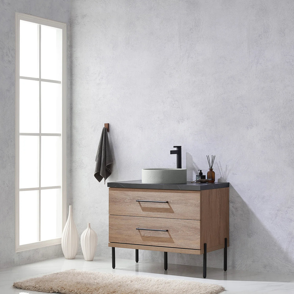 Side-on room view with a tall window and white vase close to the vanity