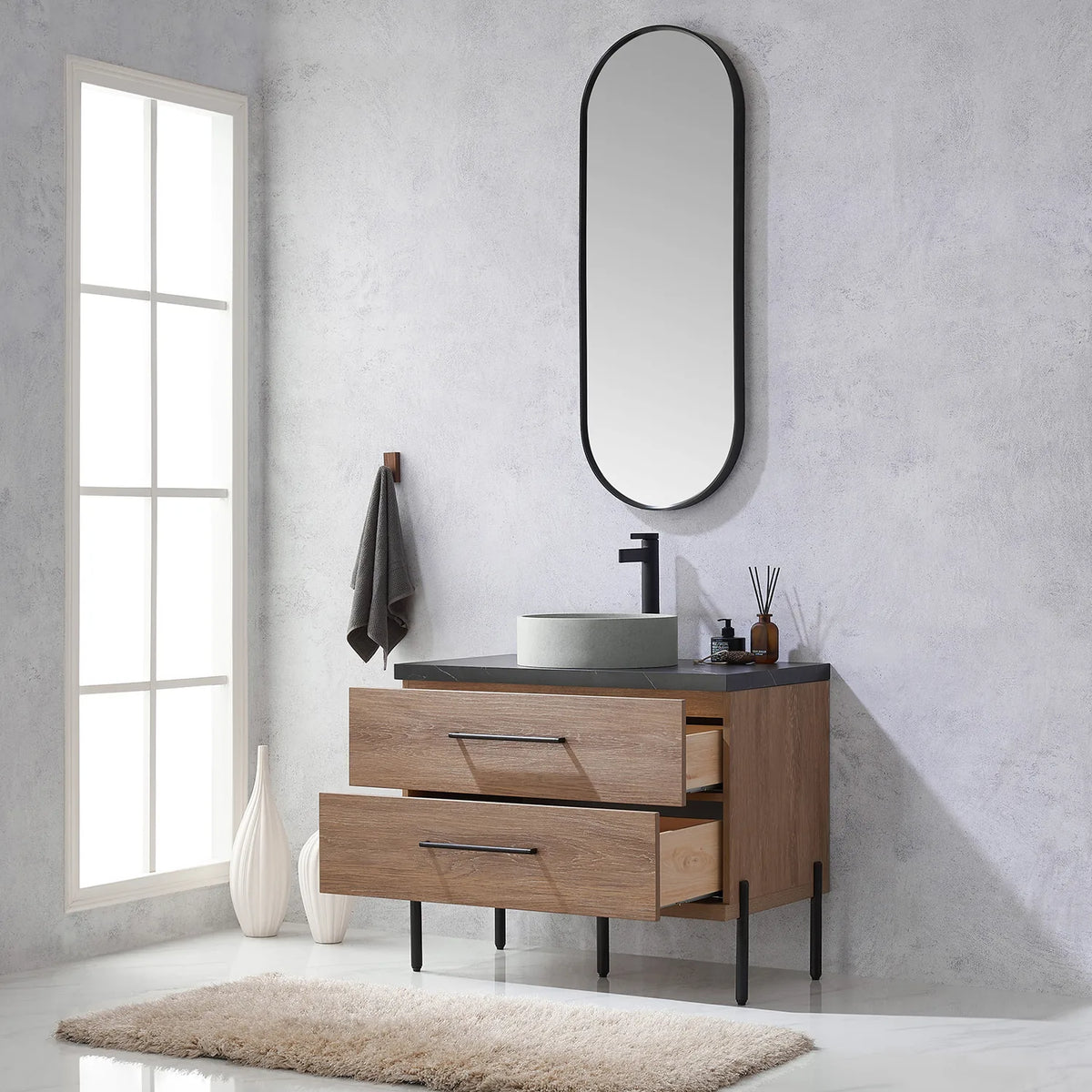 Looking up from the open drawers to the oval mirror hung on the wall
