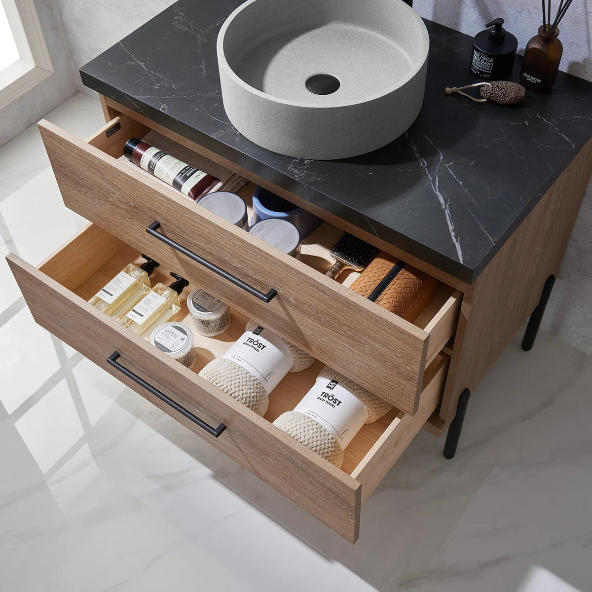 Fully open storage drawers with their contents arranged by type
