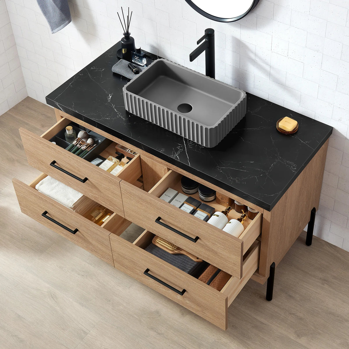 Angled oak cabinet with the drawers open and trays of bottles inside